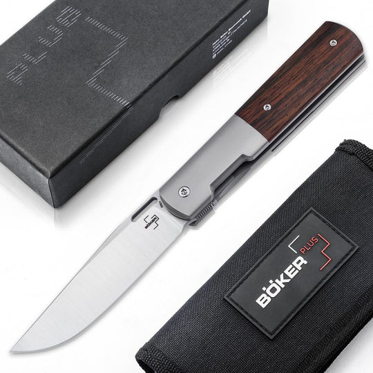 Boker Urban Barlow folding knife with cocobolo wood handle, titanium frame, and M390 steel blade, shown with box and pouch.