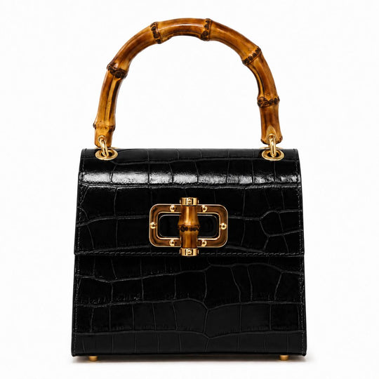 Black crocodile-embossed leather mini bag with a bamboo top handle and gold-tone clasp closure.