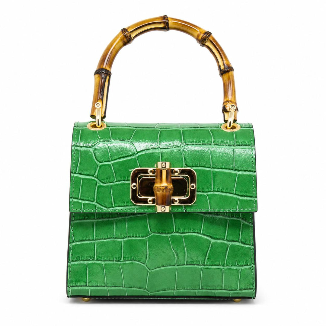 Green crocodile-embossed leather mini bag with bamboo top handle and gold clasp closure.