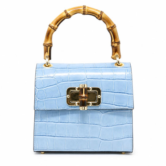 Light blue crocodile-embossed leather mini bag with a bamboo top handle and gold-tone clasp closure.