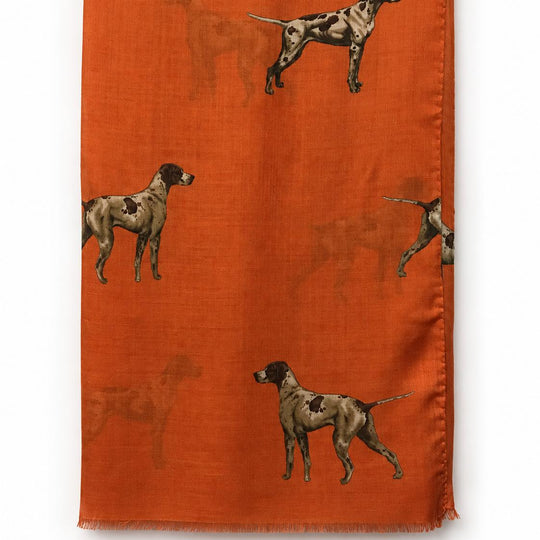 Burnt orange silk and wool scarf featuring a repeating pattern of brown and white hunting dogs with fringed edges.