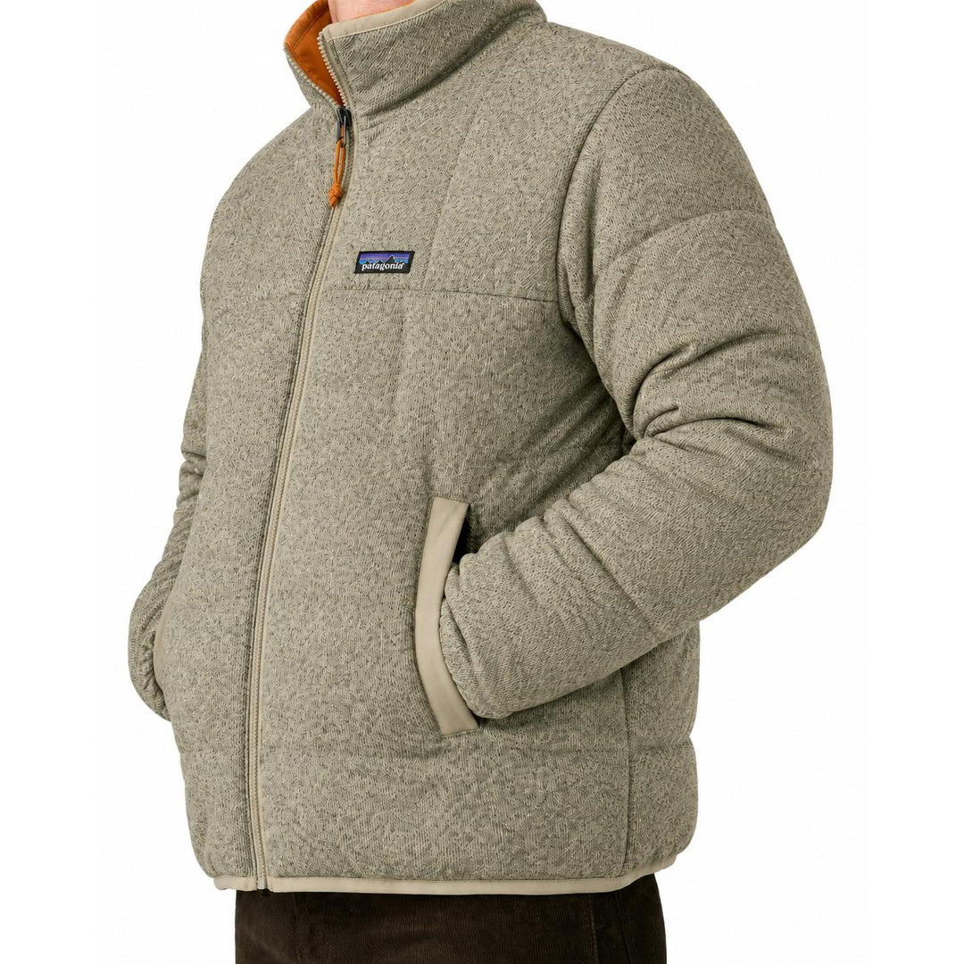 Patagonia men's reversible down sweater in heathered beige knit fleece with a full-zip front and side pockets.