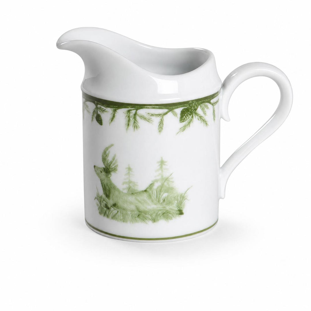 White porcelain creamer featuring a green forest motif with a proud buck and pine branch accents.