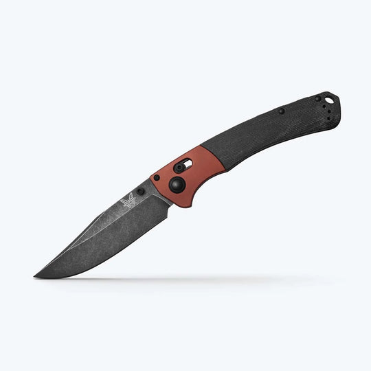 Benchmade Crooked River folding knife with a black clip-point blade, red pivot bolster, and textured black handle.