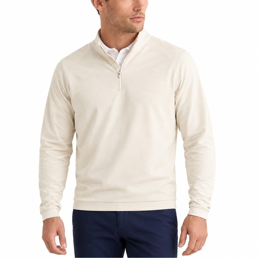 Man wearing a cream-colored Peter Millar Perth performance quarter-zip pullover with subtle stripes and a mock collar.