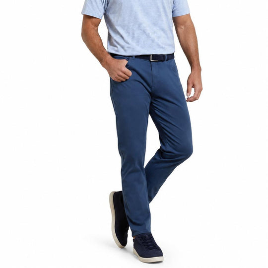 Peter Millar blue sateen five-pocket pants with a comfort waistband and classic fit, paired with a striped polo shirt.