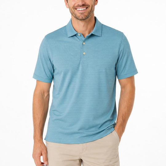Man wearing a blue Peter Millar performance jersey polo with a self-fabric collar and three-button placket.