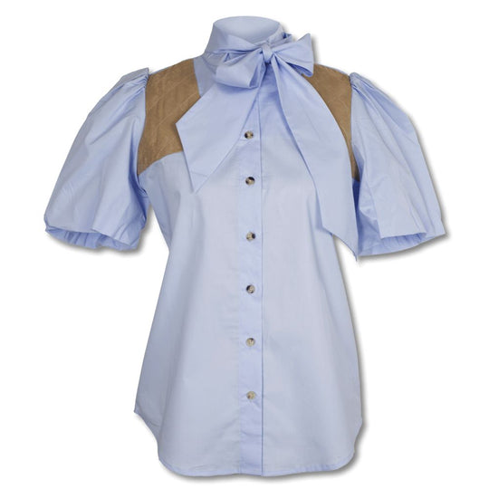 Light blue button-down blouse with puff sleeves, a neck tie, and tan suede shoulder patches for shooting.