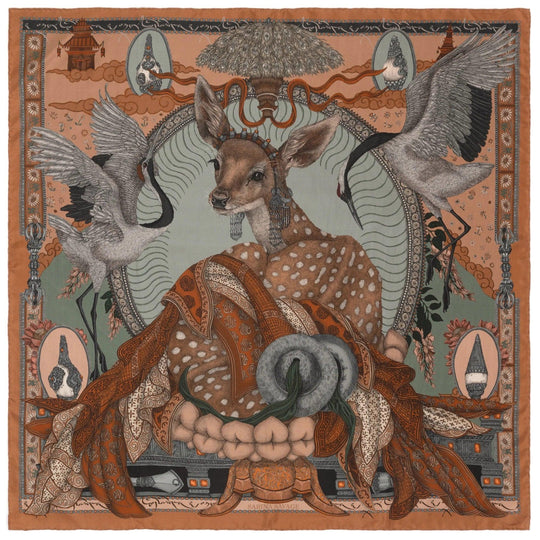 Sabina Savage 35-inch silk scarf featuring a deer, cranes, and Tibetan-inspired motifs in earthy tones with hand-rolled edges.