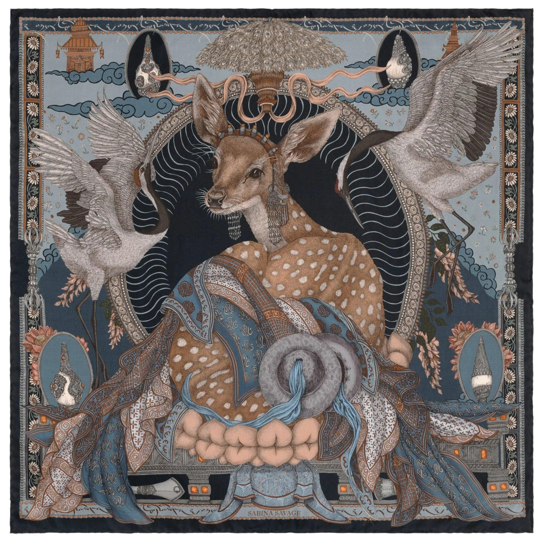 Sabina Savage 35-inch silk scarf featuring a deer, cranes, and Tibetan-inspired motifs in blue, brown, and cream tones.
