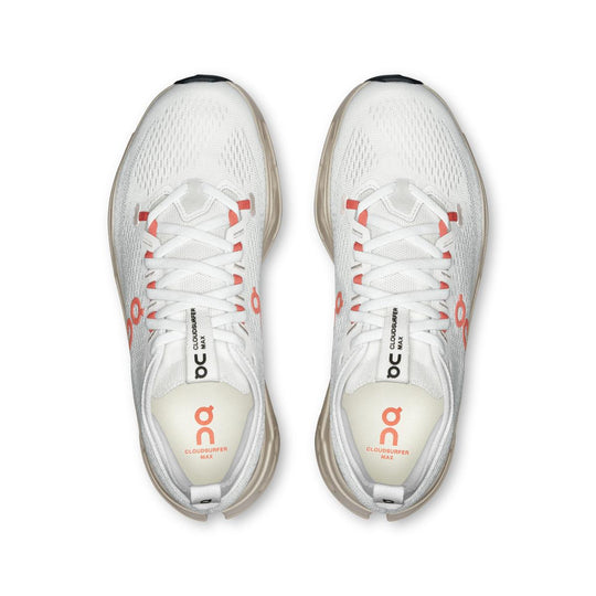Top view of white On Running Cloudsurfer Max women's shoes with coral accents and a breathable mesh upper.