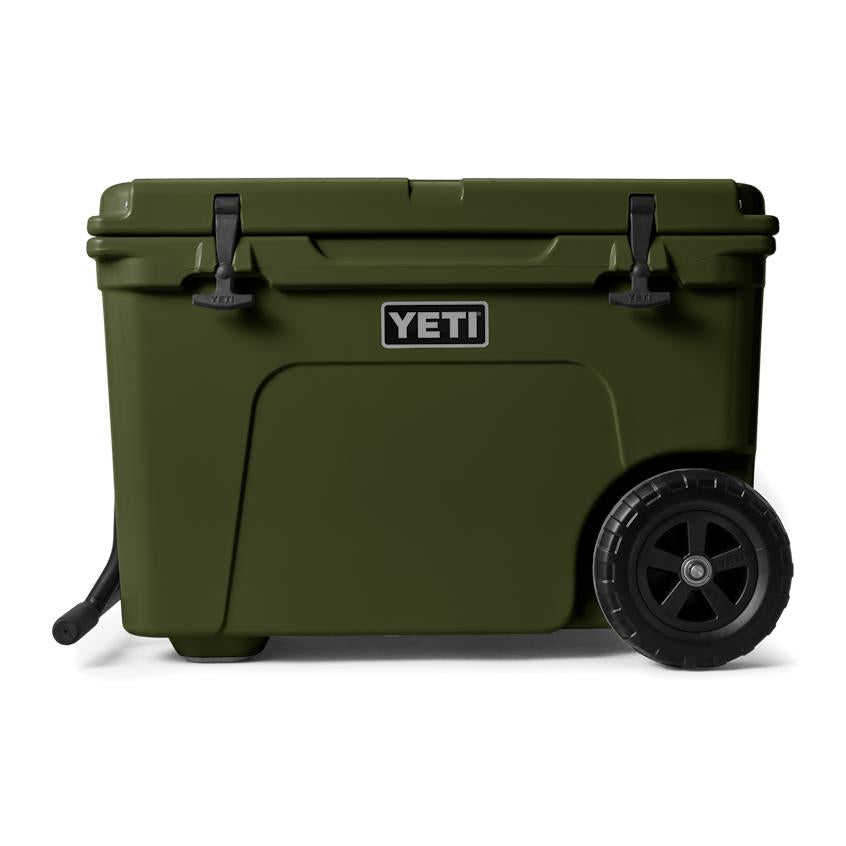 Olive green YETI Tundra Haul wheeled cooler with black T-latches, rugged wheels, and a sturdy side handle.