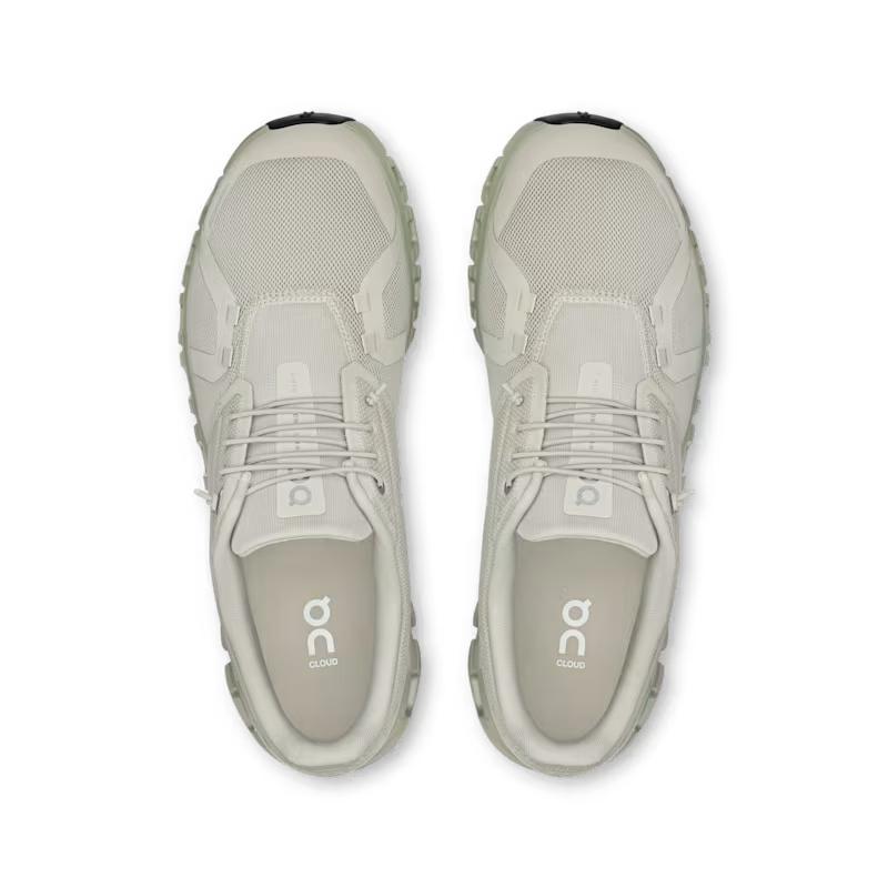 Top-down view of light beige On Running Cloud 6 men's sneakers featuring breathable mesh and signature cushioned soles.