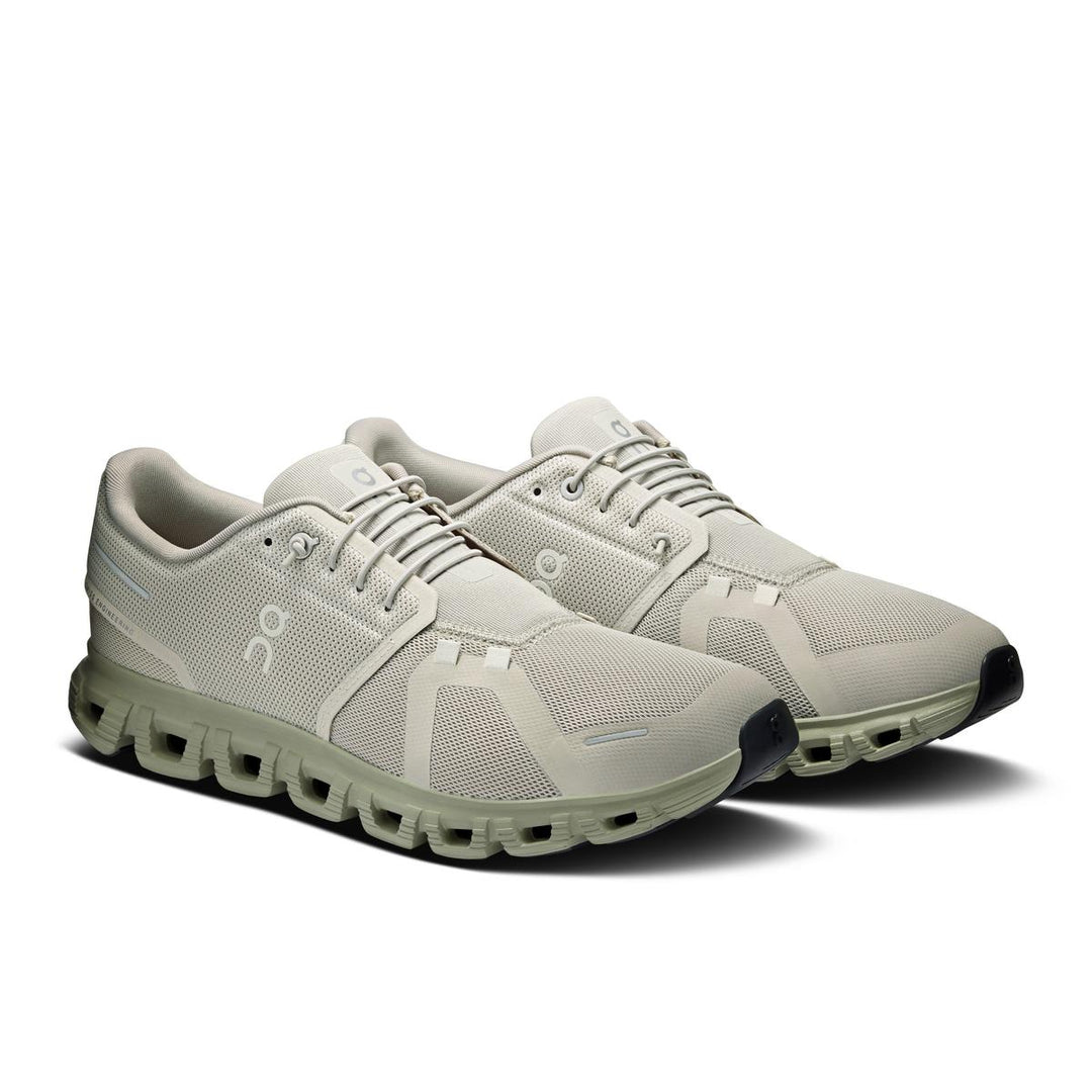 On Running Cloud 6 men's sneaker in light beige with signature CloudTec cushioned sole and breathable mesh upper.