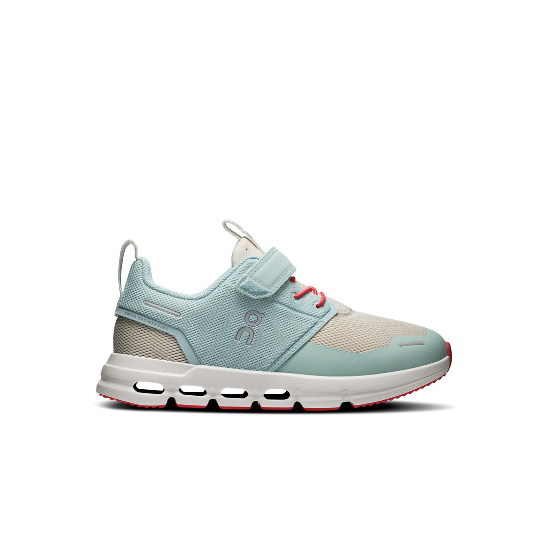 Light blue and beige On Running Cloud Play kids sneaker with a hook-and-loop strap, white CloudTec sole, and red accents.