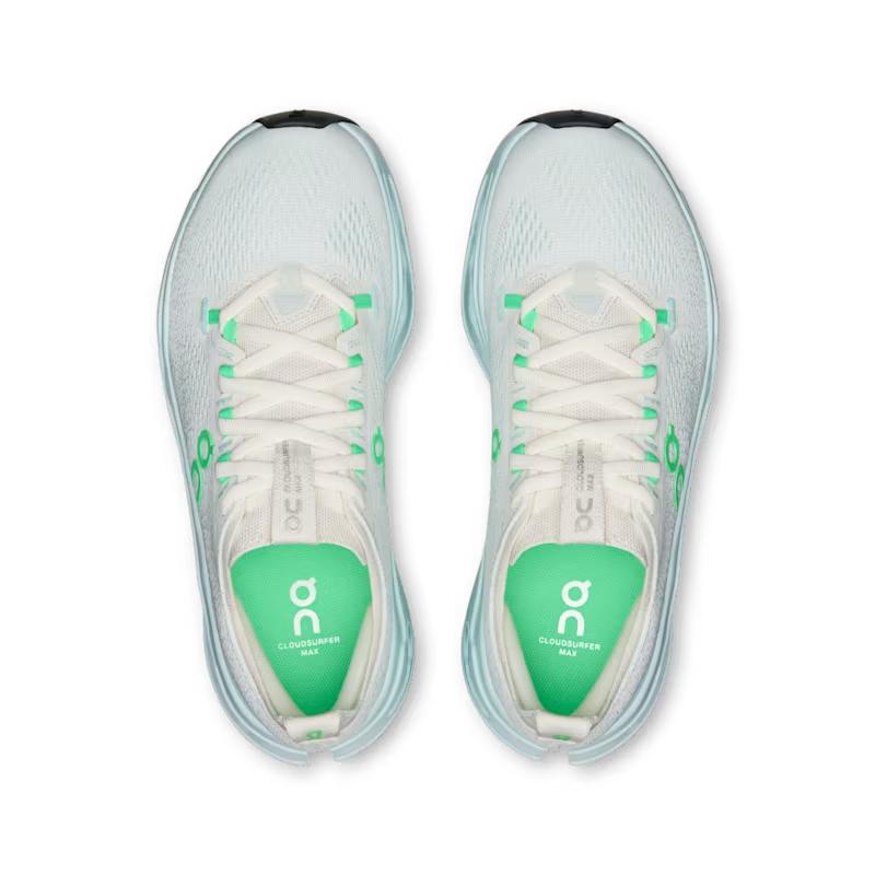 Top view of light blue On Running Cloudsurfer Max women's shoes with bright green accents and cushioned mesh uppers.