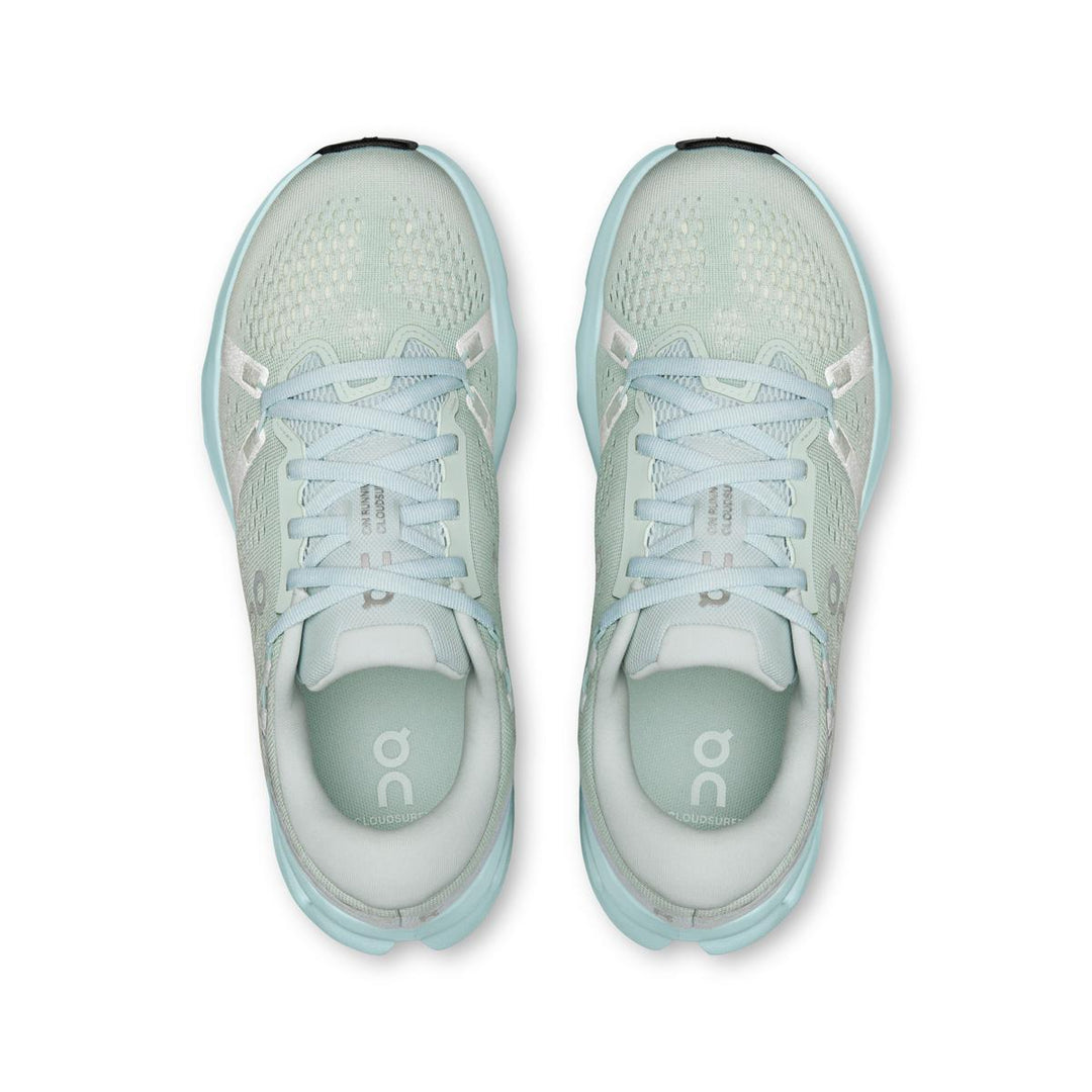 Top view of light mint green On Running Women's Cloudsurfer 2 sneakers with breathable mesh and cushioned soles.