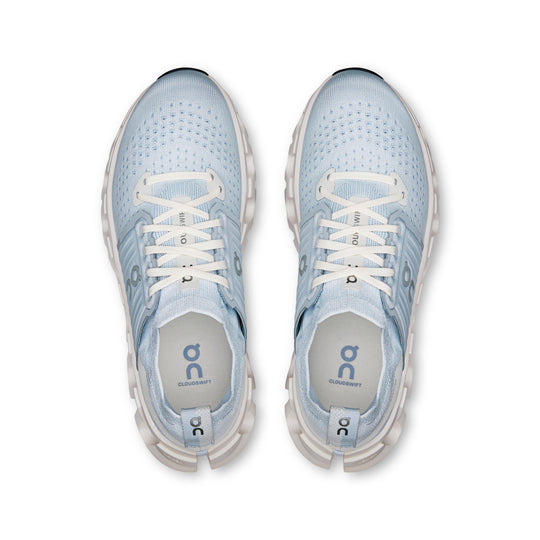 Top-down view of light blue On Running Cloudswift 4 women's sneakers with white laces and cushioned Helion foam midsoles.