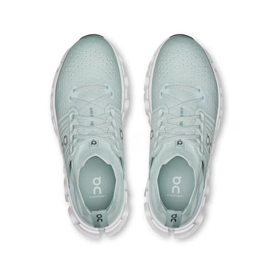 Top-down view of light green On Running Cloudswift 4 women's shoes featuring a breathable mesh upper and white sole.