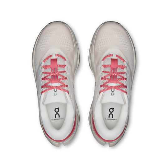 Top view of white On Running Cloudrunner 3 women's shoes with breathable mesh, pink laces, and supportive heel clips.