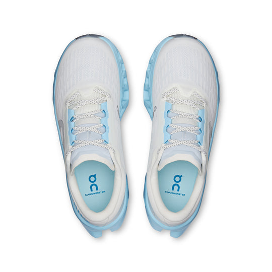 Top view of white and light blue On Cloudmonster 3 running shoes with breathable knit uppers and cushioned soles.