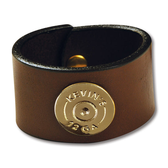 Brown leather napkin ring featuring a gold 12-gauge shotshell concho with Kevin's branding.