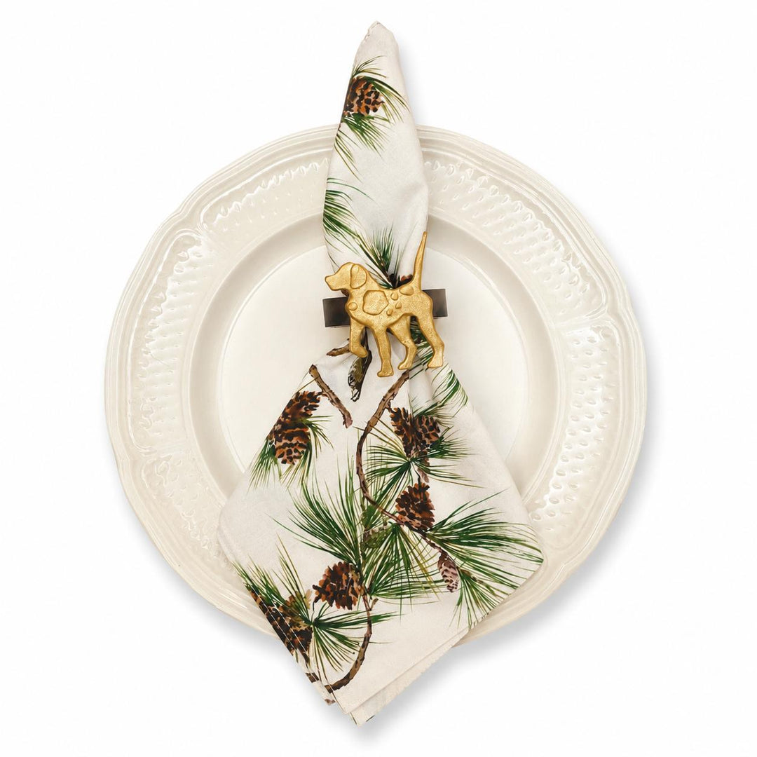 Soft cotton canvas napkin with bobwhite quail and longleaf pine print, held by a gold dog napkin ring on a white plate.