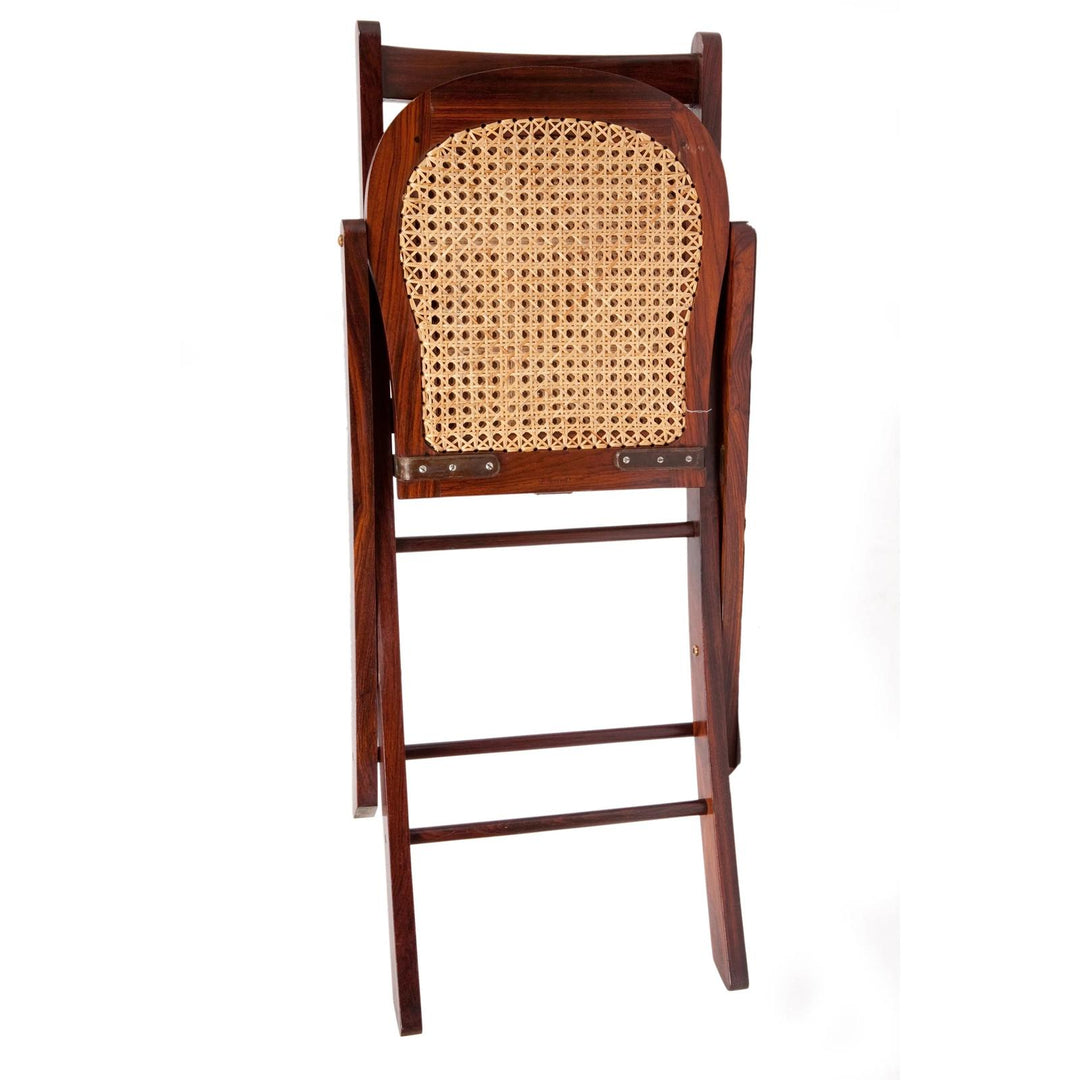 Folded Jaipur polo chair in dark solid rosewood with a natural woven cane seat back.