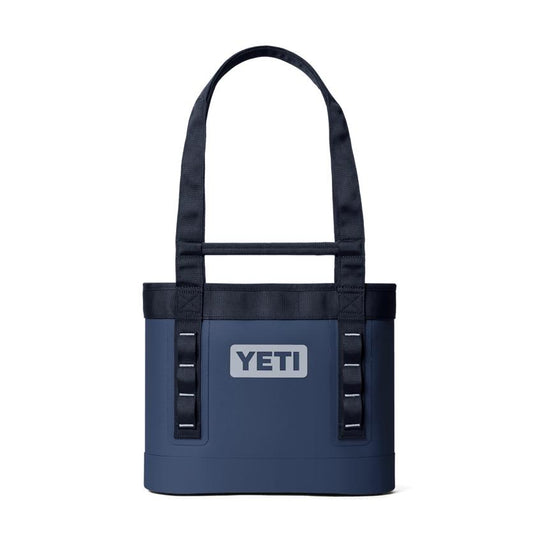 Navy blue YETI Camino 12L waterproof tote bag with durable carry straps and front gear loops on a white background.
