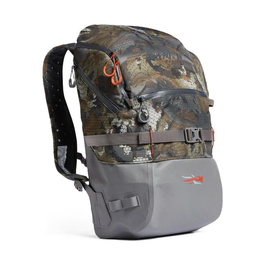 Sitka Timber Pack in camo print with a durable grey rubberized base, waterproof zippers, and adjustable chest strap.