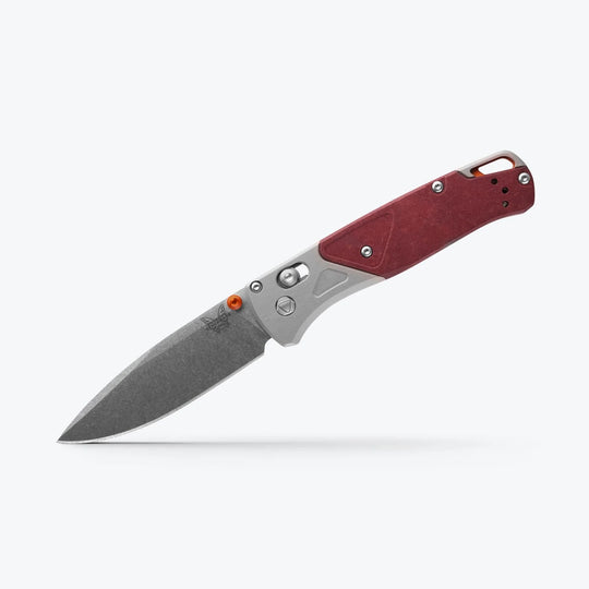 Benchmade Bugout folding knife with a grey drop-point blade, silver bolster, and textured red handle scales.