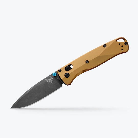 Benchmade Bugout folding knife with a tan handle, black drop-point blade, and bright blue thumb stud.