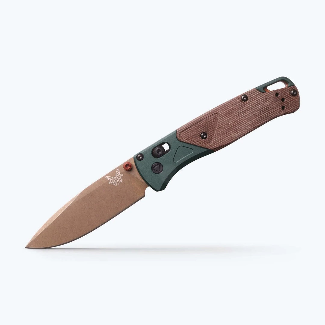 Benchmade Bugout folding knife with a tan blade, olive green bolster, and textured brown handle scales.