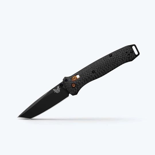 Benchmade Bailout folding knife with a black tanto blade, textured carbon fiber handle, and gold-colored thumb stud.