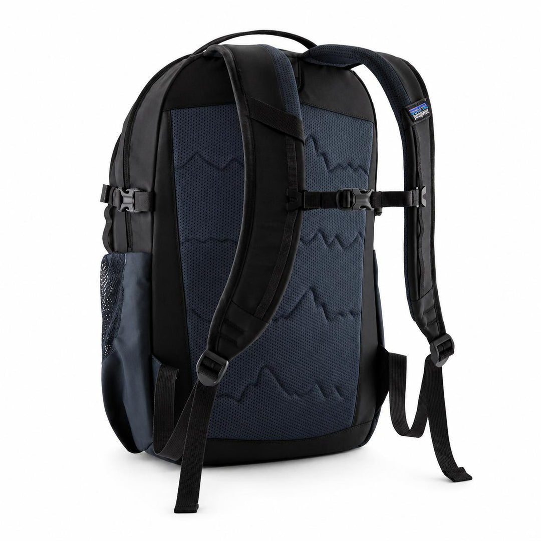 Back view of a black and navy Patagonia Refugio 26L backpack with a breathable mesh back panel and padded shoulder straps.