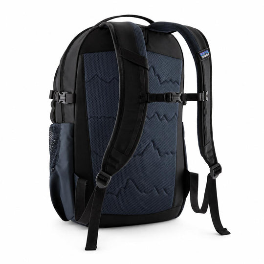 Back view of a black and navy Patagonia Refugio 26L backpack with a breathable mesh back panel and padded shoulder straps.