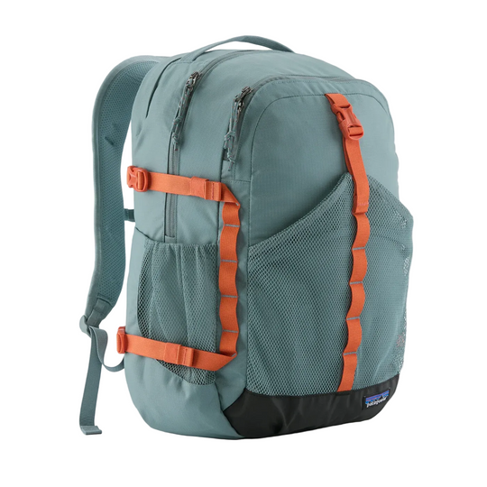 Patagonia Refugio 30L daypack in sage green with orange compression straps, mesh front pocket, and black base.