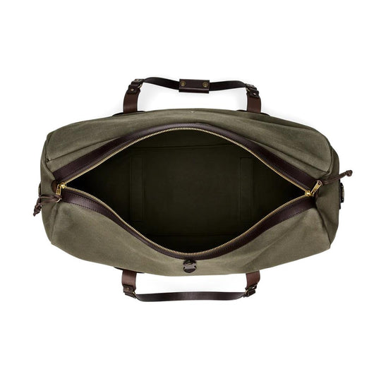 Top-down view of an open olive green Rugged Twill duffle bag with brown Bridle Leather handles and brass zipper hardware.
