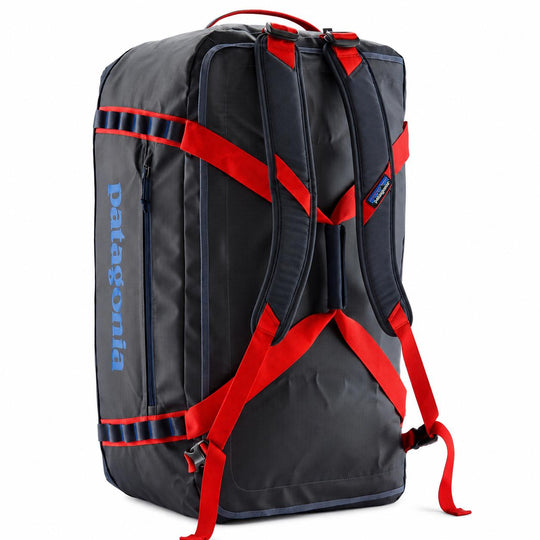 Black Patagonia Black Hole 70L duffel bag with red backpack straps, side daisy chains, and blue logo on a white background.