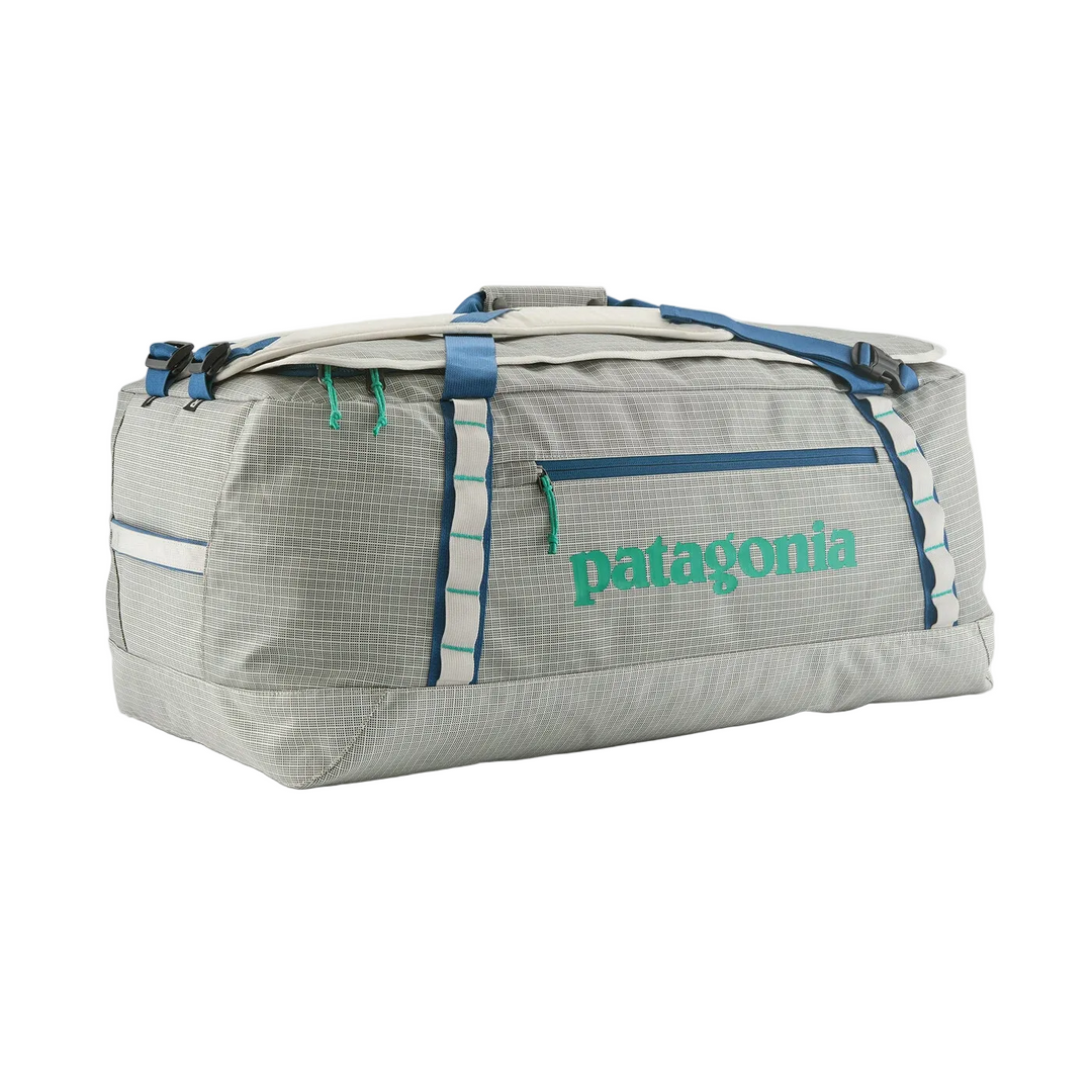 Patagonia Black Hole 70L duffel bag in grey grid pattern with blue straps, green logo, and daisy chain lash points.