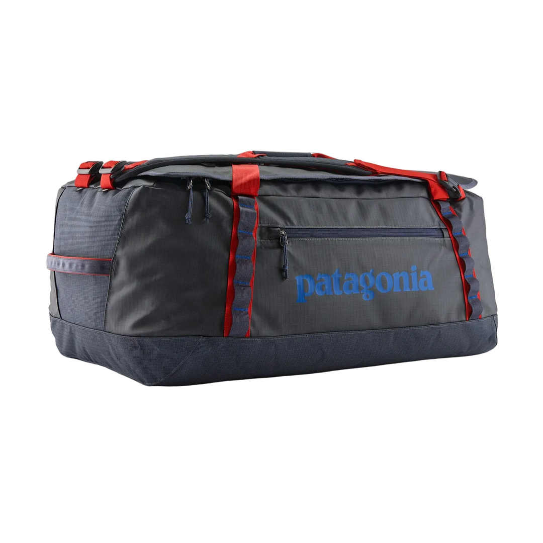 Patagonia Black Hole 70L duffel bag in dark grey with red straps, daisy chains, and blue logo on a white background.