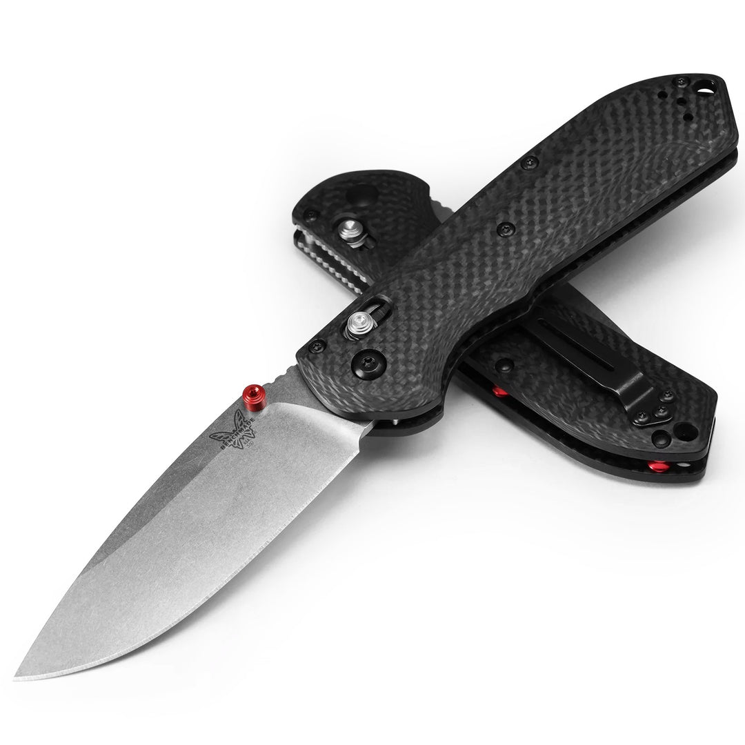 Benchmade Freek folding knife with a gray CPM-M4 steel blade and textured black G10 handle with red accents.