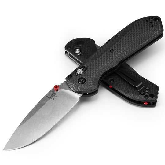 Benchmade Freek folding knife with a gray CPM-M4 steel blade and textured black G10 handle with red accents.