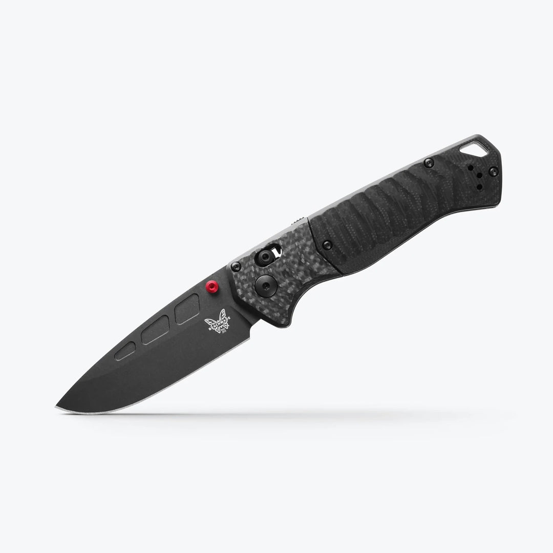 Benchmade 593 PSK folding knife with black Cerakote blade, carbon fiber handle, and red thumb stud on a white background.