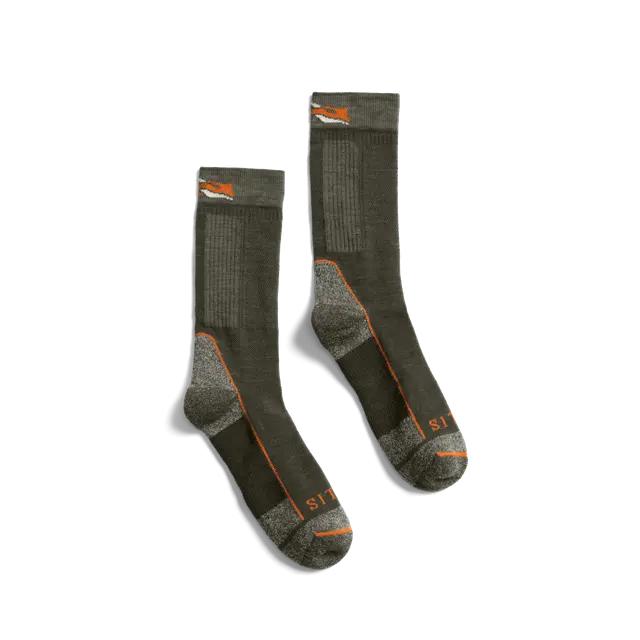 Olive green Sitka mid-weight merino wool crew socks with reinforced grey heels, toes, and orange branding accents.