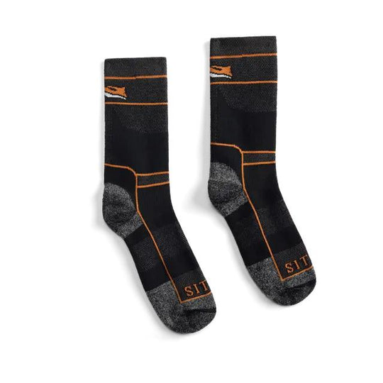 A pair of black crew socks with gray knit heel and toe sections, accented by thin orange stripes and the brand name 'SIT' in orange near the toes.