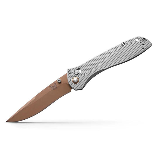 Benchmade 710 25th Anniversary folding knife with a copper-colored recurved blade and textured silver metal handle.