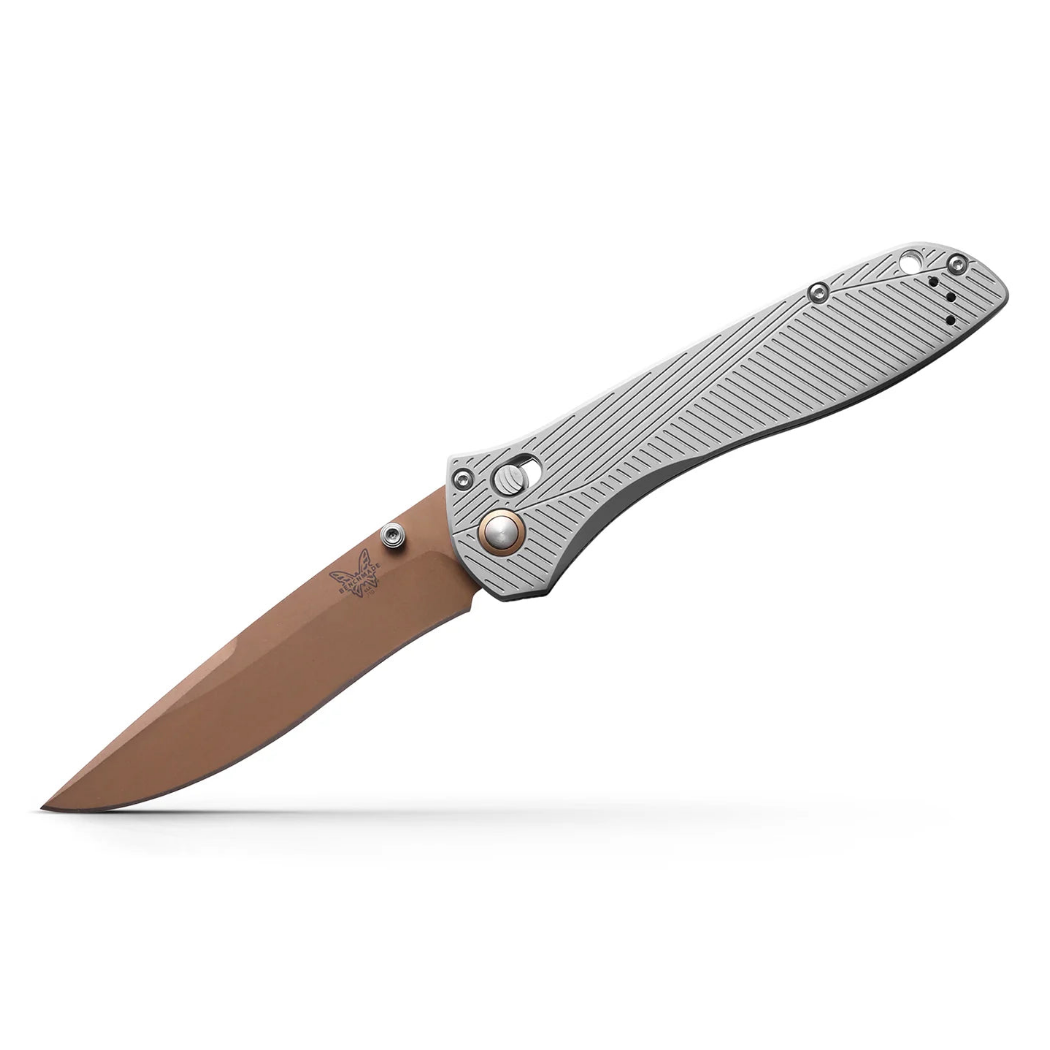 Benchmade 710 25th Anniversary folding knife with a copper-colored recurved blade and textured silver metal handle.