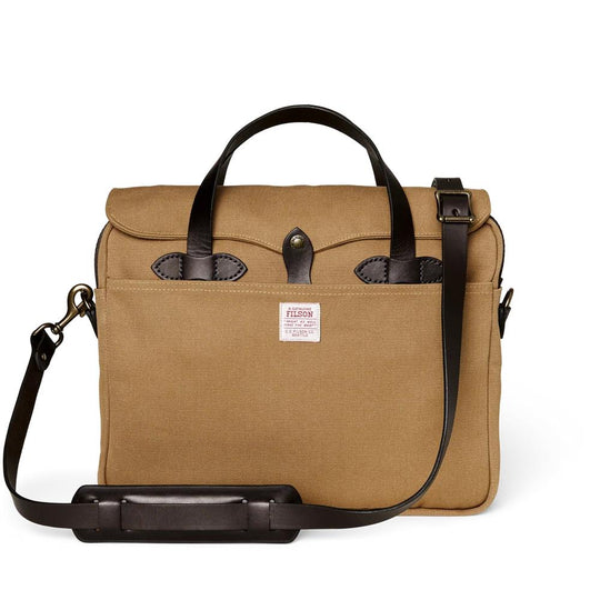 Tan Filson Rugged Twill briefcase with dark brown bridle leather handles, shoulder strap, and brass hardware details.