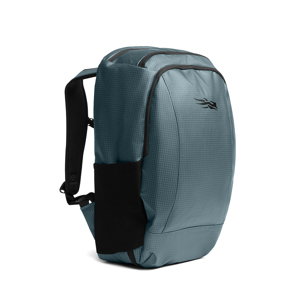 Blue-grey Sitka Drifter travel pack made of durable ripstop fabric with black mesh side pocket and padded straps.